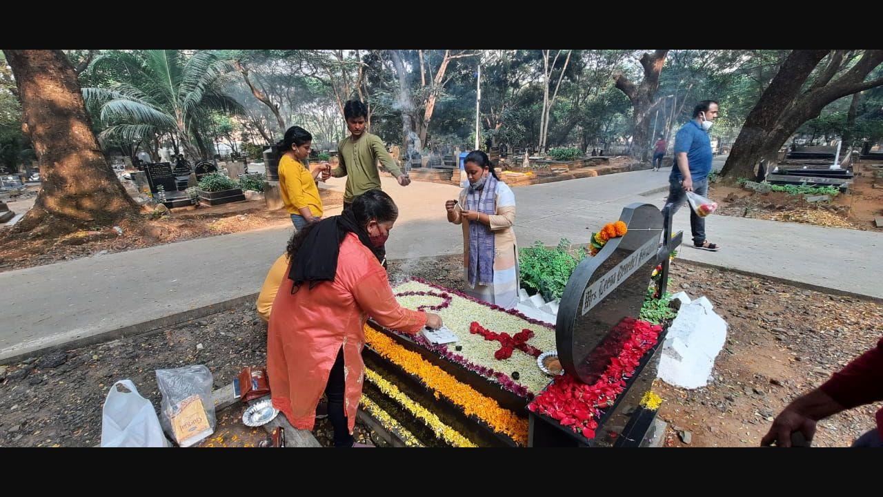 It is a tradition on this day to hold requiem masses, and for people to visit and decorate the graves of loved ones. A family lays flowers for a departed loved one at Mumbai's Sewri cemetery. Photo: Pradeep Dhivar/Mid-day